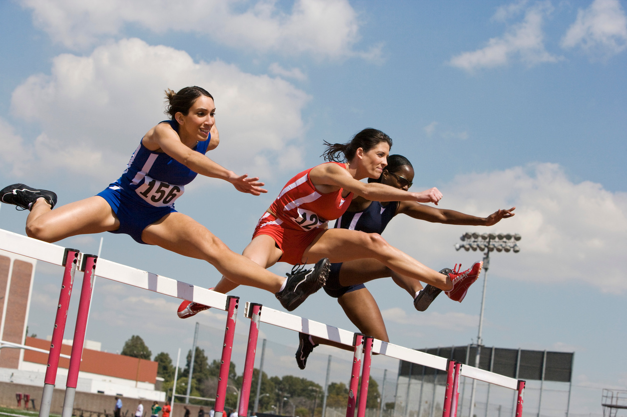 Female athletes hurdling